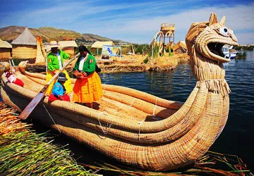 Traditionally dressed Uros women embarking on a reed ship