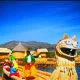 Mini Cover. Uros women of Lake Titicaca in a totora ship