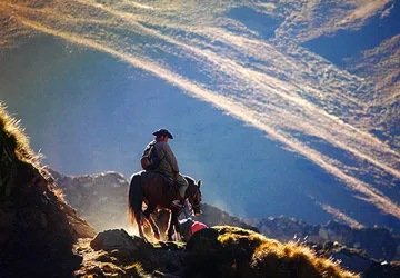 Lone rider overlooking the peaks along the Salkantay Trail.