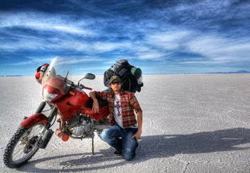 Traveler motorcycle riding through Uyuni Salar, Bolivia