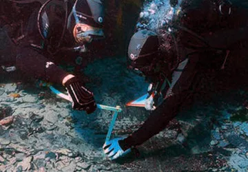 Divers excavating in Lake Titicaca for archeological remains