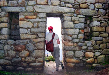Relaxing in a stone doorway at Machu Picchu site