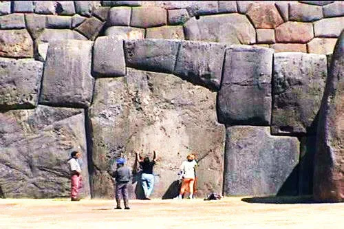 Visitors observing the massive stones of Sacsayhuaman Fortre