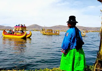 Uros woman watching the boats on Lake Titicaca near Puno.