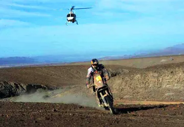 Dakar Rally motorcyclist races through the Peruvian desert.