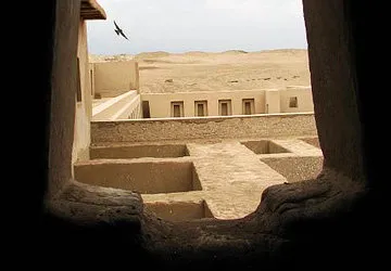Looking through window at Pachacamac's adobe structures