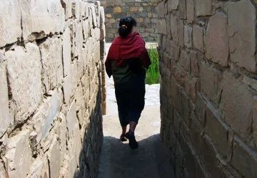 Woman walking along a prehispanic passageway