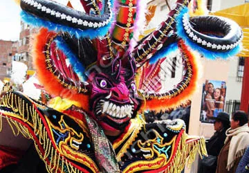One of the grinning devils of Lake Titicaca joins the festiv