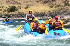 Rafters on the Chuquicahuana River rapids nearby Cusco Peru