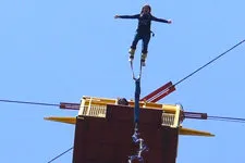 Girl leaping from bungee lift near Cusco Peru