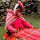 Traditionally dressed woman weaving in Cusco, Peru.