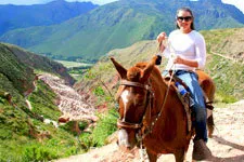 Young woman riding horse to the Moray Archeological Complex.