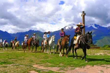 Riding horses to the Maras Salt Pans from Moray terraces in 