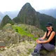 Girl overlooking the Inca city of Machu Picchu in Peru