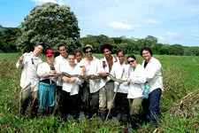 Group carrying a boa in the marshlands of Bolivia near Rurre