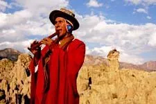 Musician playing flute in the Valley of the Moon near La Paz