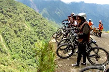 Bikers looking into the abyss from Death Road near La Paz, B