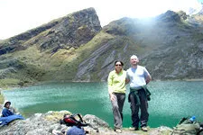 Couple of trekkers in front of glacier lagoon near La Paz, B