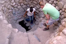 Travelers entering an ancient Cantayoc aqueduct in Nazca, Pe