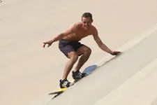 Sandboarding down the largest sand dune, White Hill in Nazca