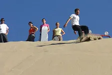 Extreme adventure sandboarding down White Hill in Nazca, Per