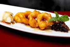Plate of traditional picarones desert during dinner show in 