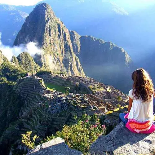 Cover Photo. Couple visiting the Inca ruins of Machu Picchu 